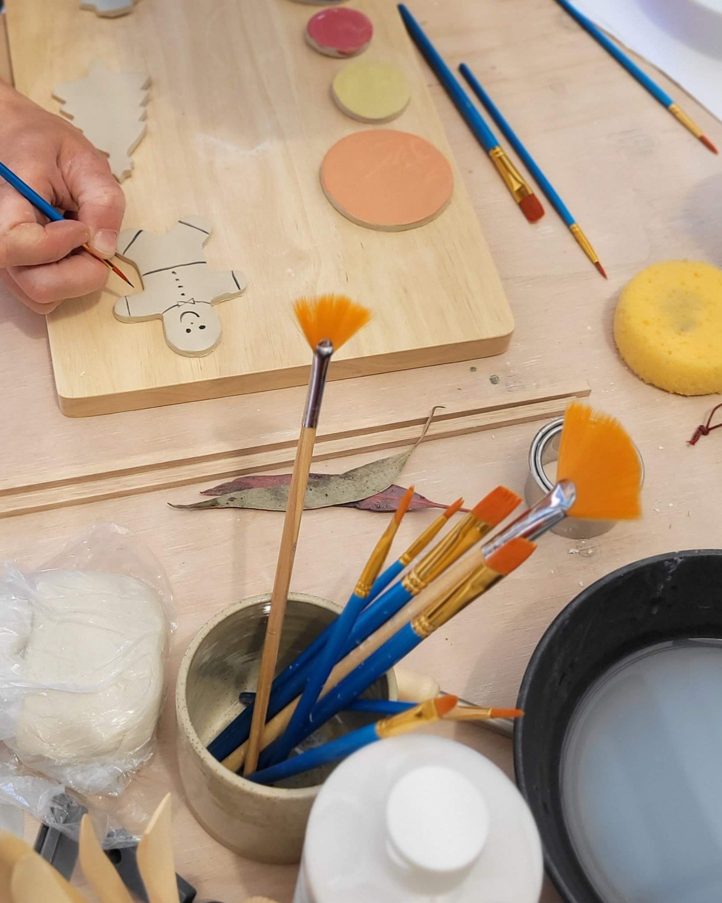 Person working with clay and tools on a table