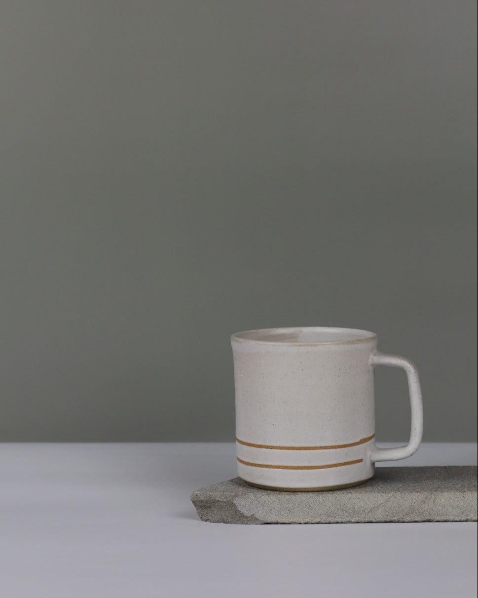 White mug with two stripes on a grey background