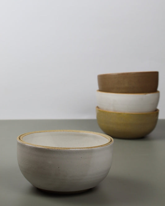 Stack of ceramic bowls on a plain background