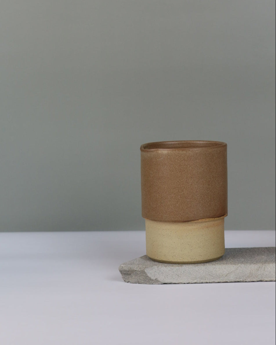 Brown ceramic jug against a grey background