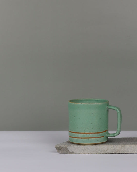 Turqoise ceramic mug on a grey background