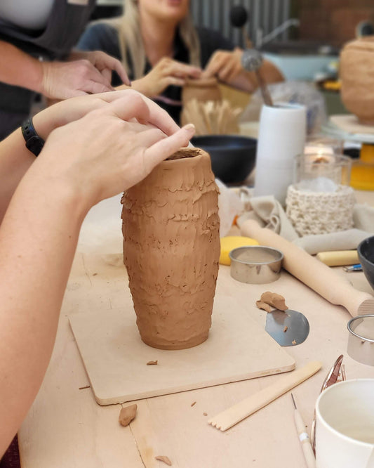 Person making a vase using clay