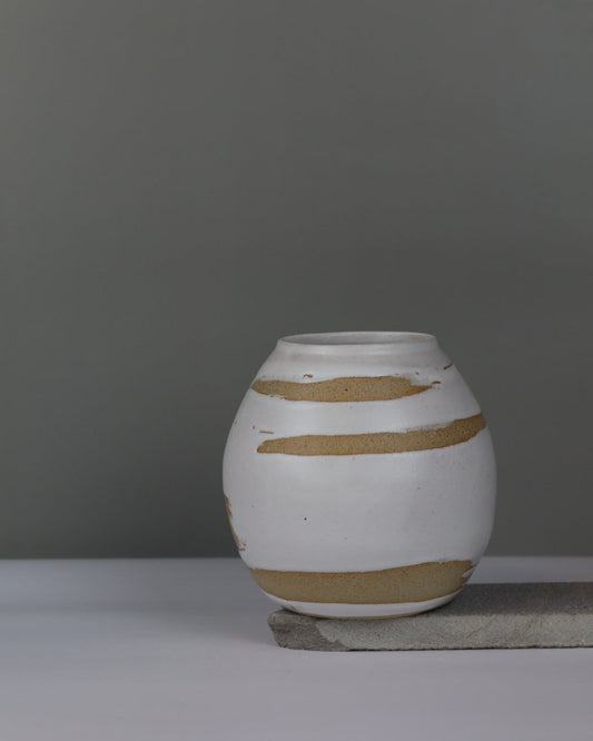 ceramic vase with white brushstrokes on a grey background