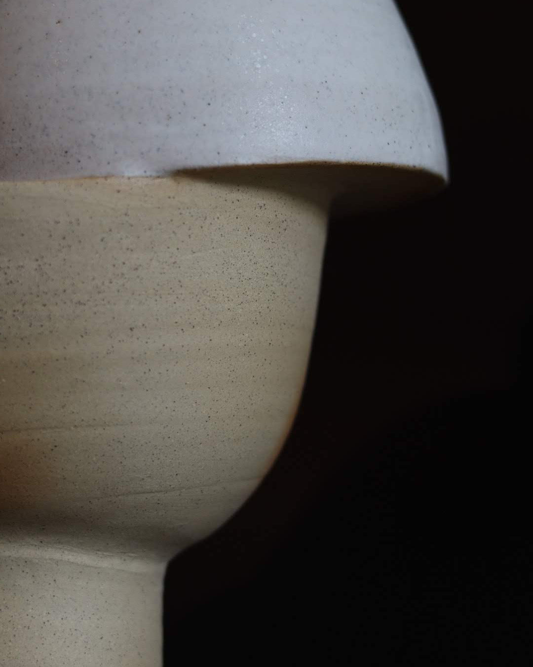 Close up of a ceramic sculpture on a black background