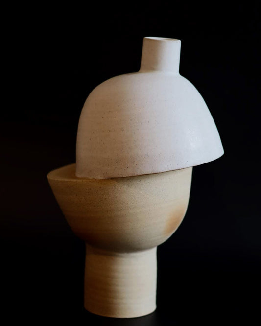 Sculptural ceramic piece with a dark background