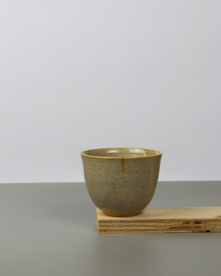 Ceramic teacup on a wooden shelf