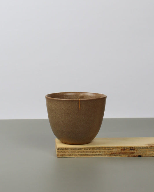 Brown teacup on a wooden shelf