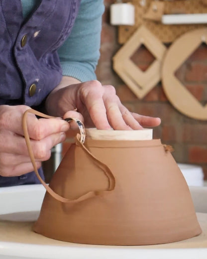 Trimming a bowl on the pottery wheel
