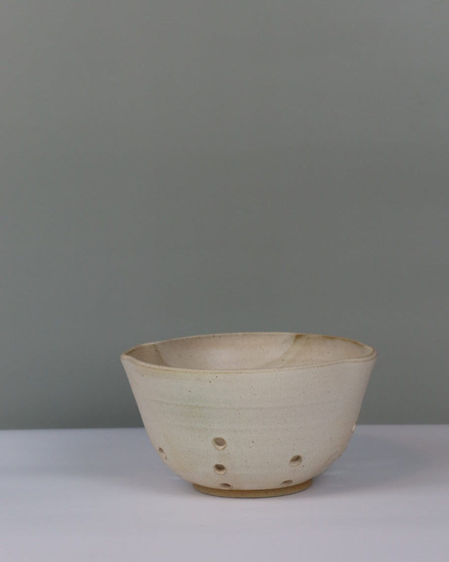 beige berry bowl on a grey background