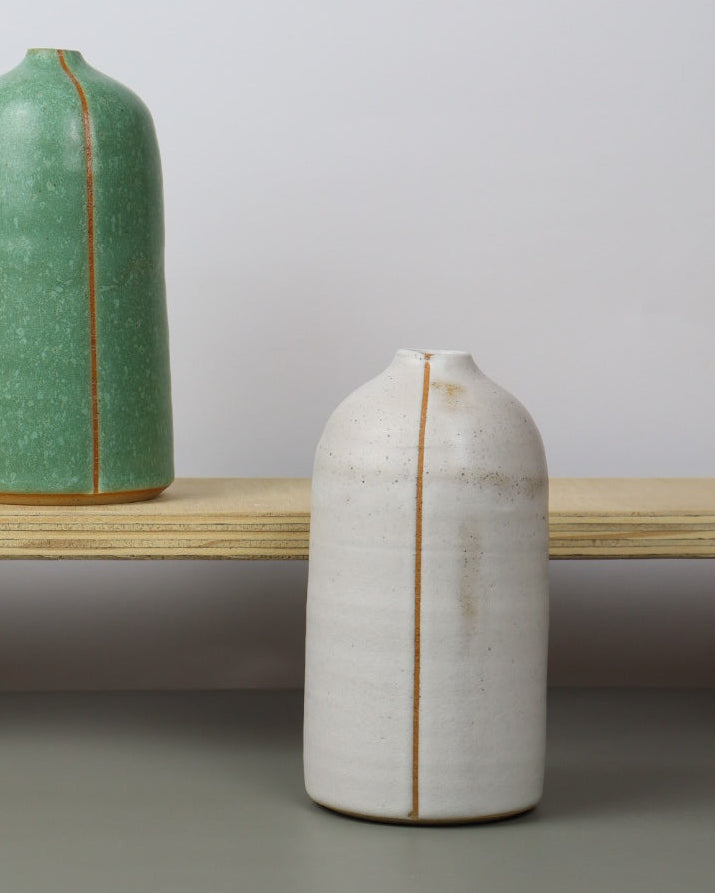 ceramic vases on a wooden shelf