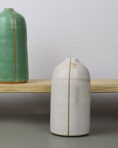 ceramic vases on a wooden shelf