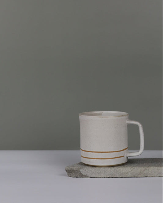 White mug with two stripes on a grey background