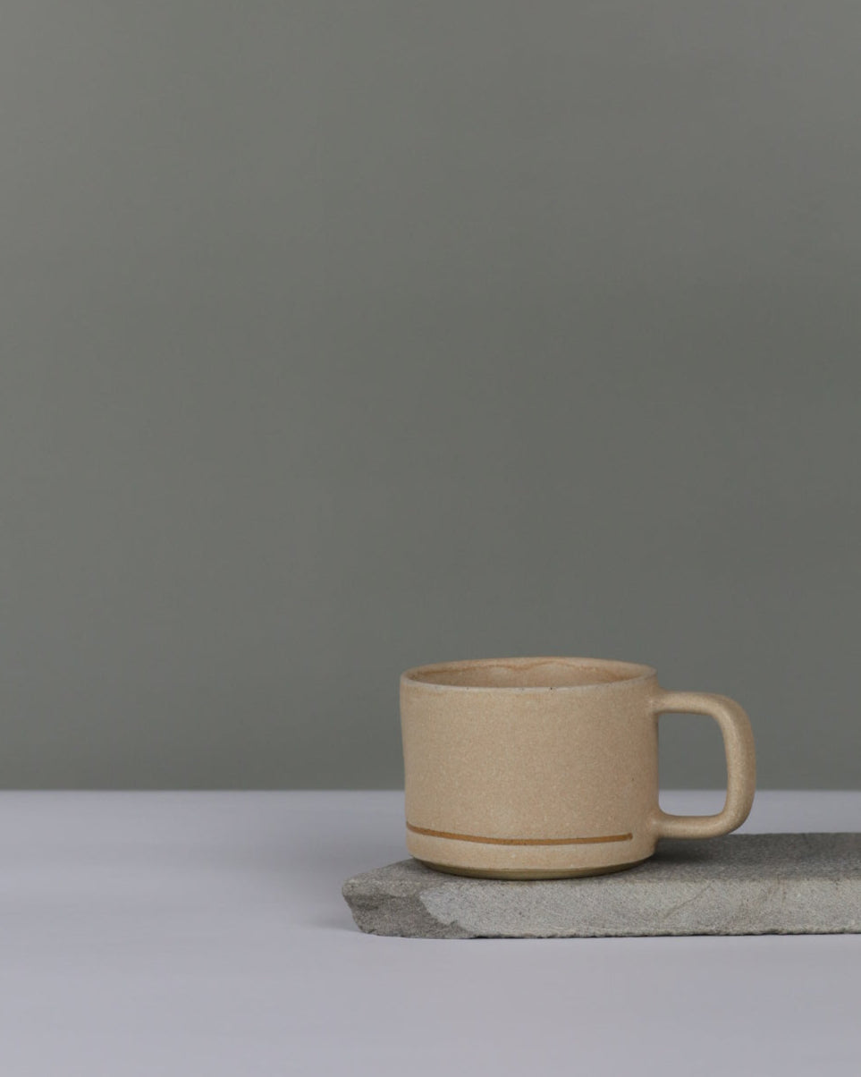 ceramic mug in oatmeal colour on a grey background