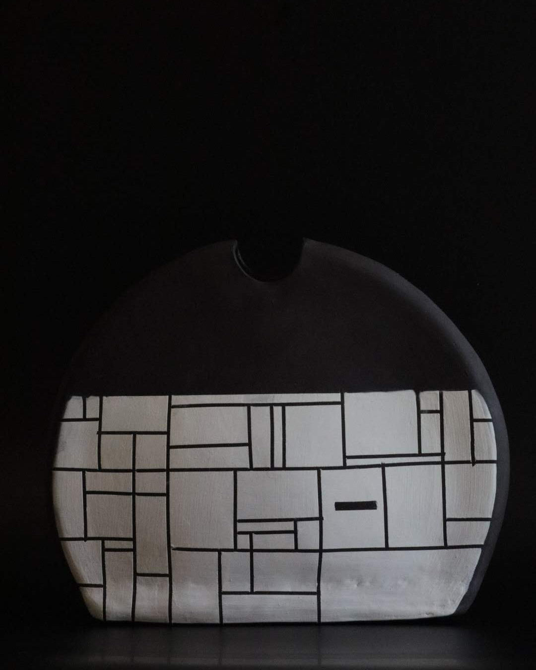 Black ceramic vessel with geometric block design