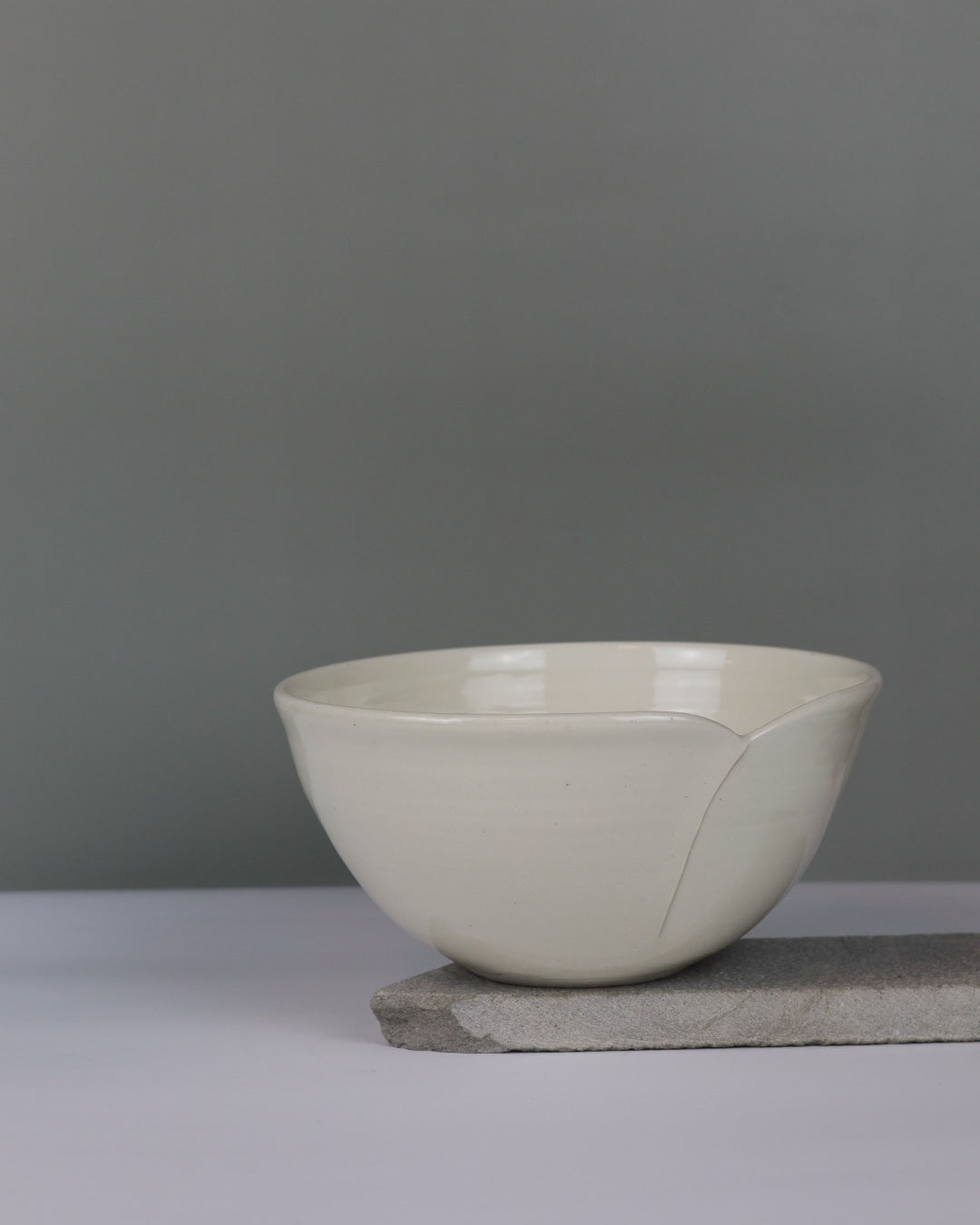 White ceramic bowl against a gray wall