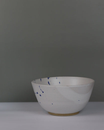 white and blue ceramic bowl on a grey background