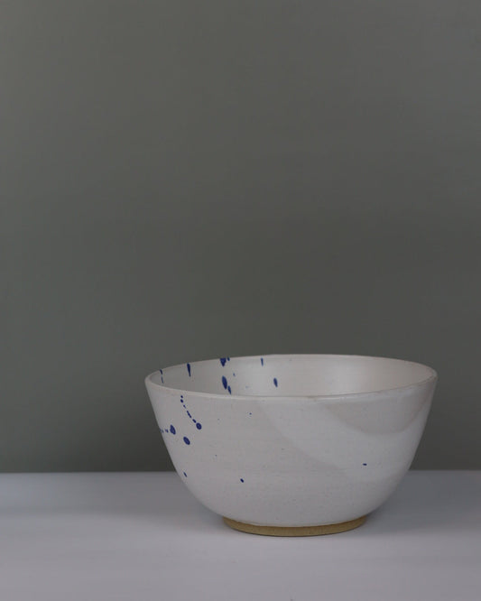 white and blue ceramic bowl on a grey background