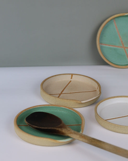 set of ceramic spoon rests with a wooden spoon