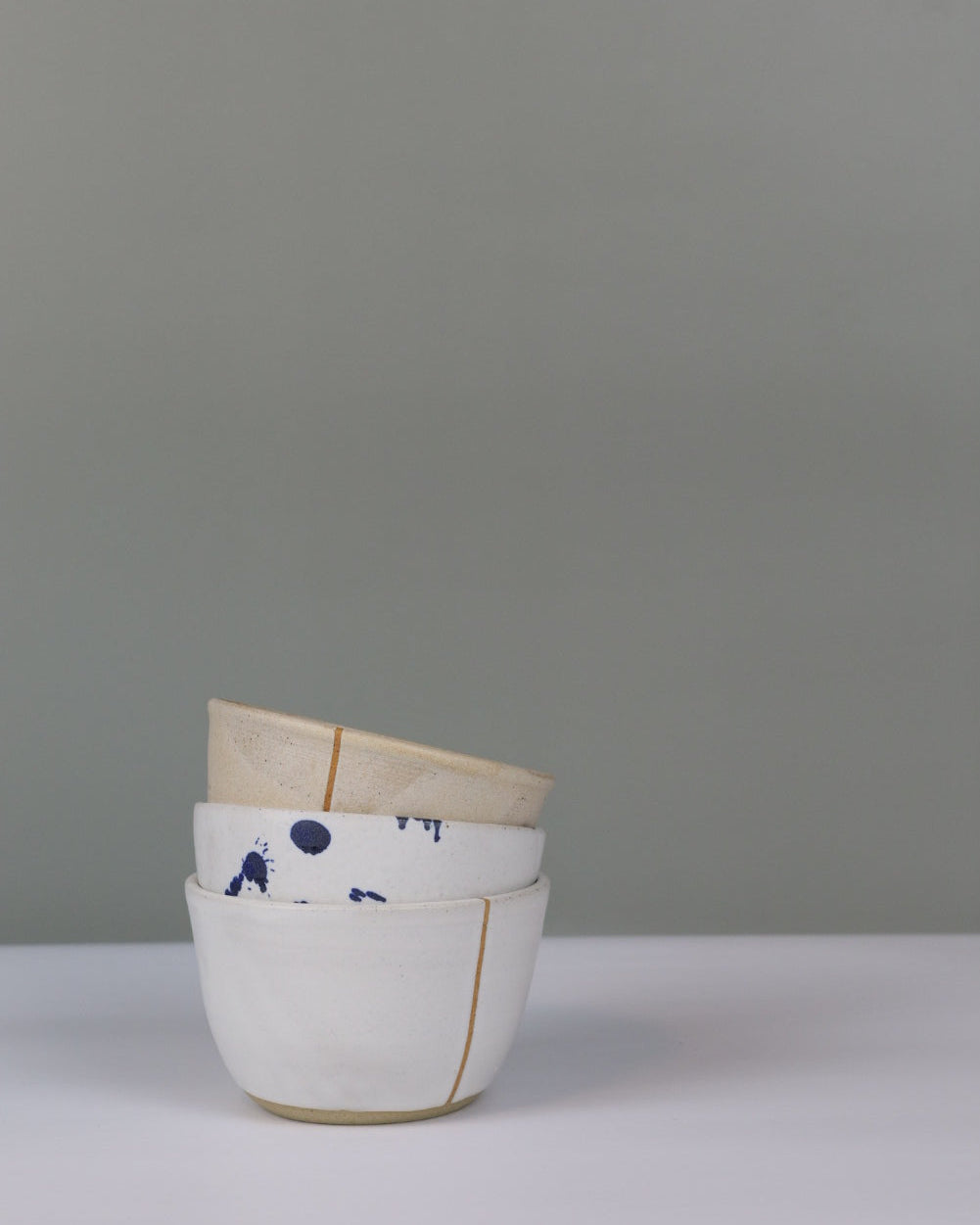 stack of three small ceramic bowls in different colours