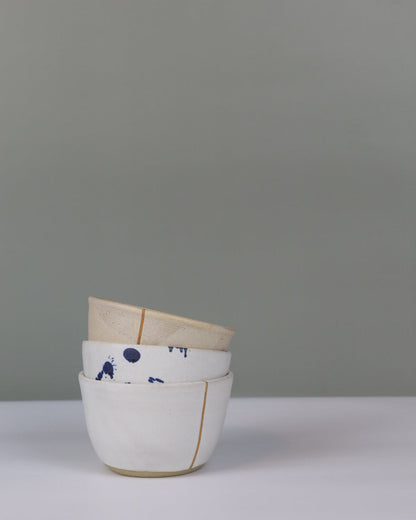 stack of three small ceramic bowls in different colours