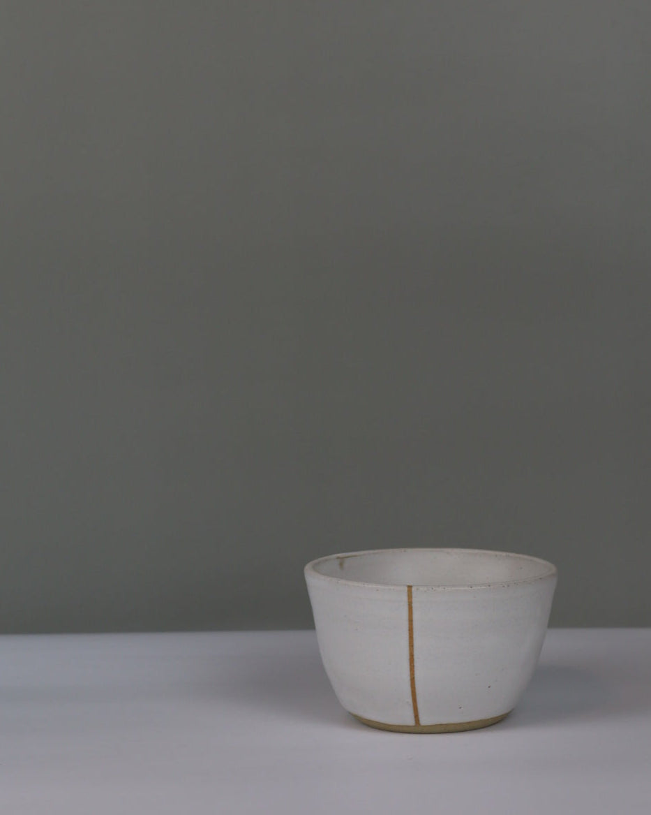 small white ceramic bowl on a grey background