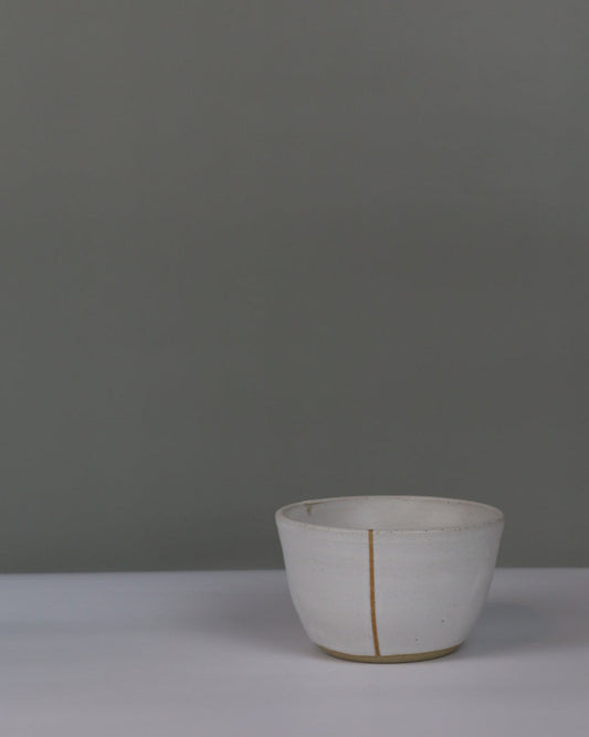 small white ceramic bowl on a grey background