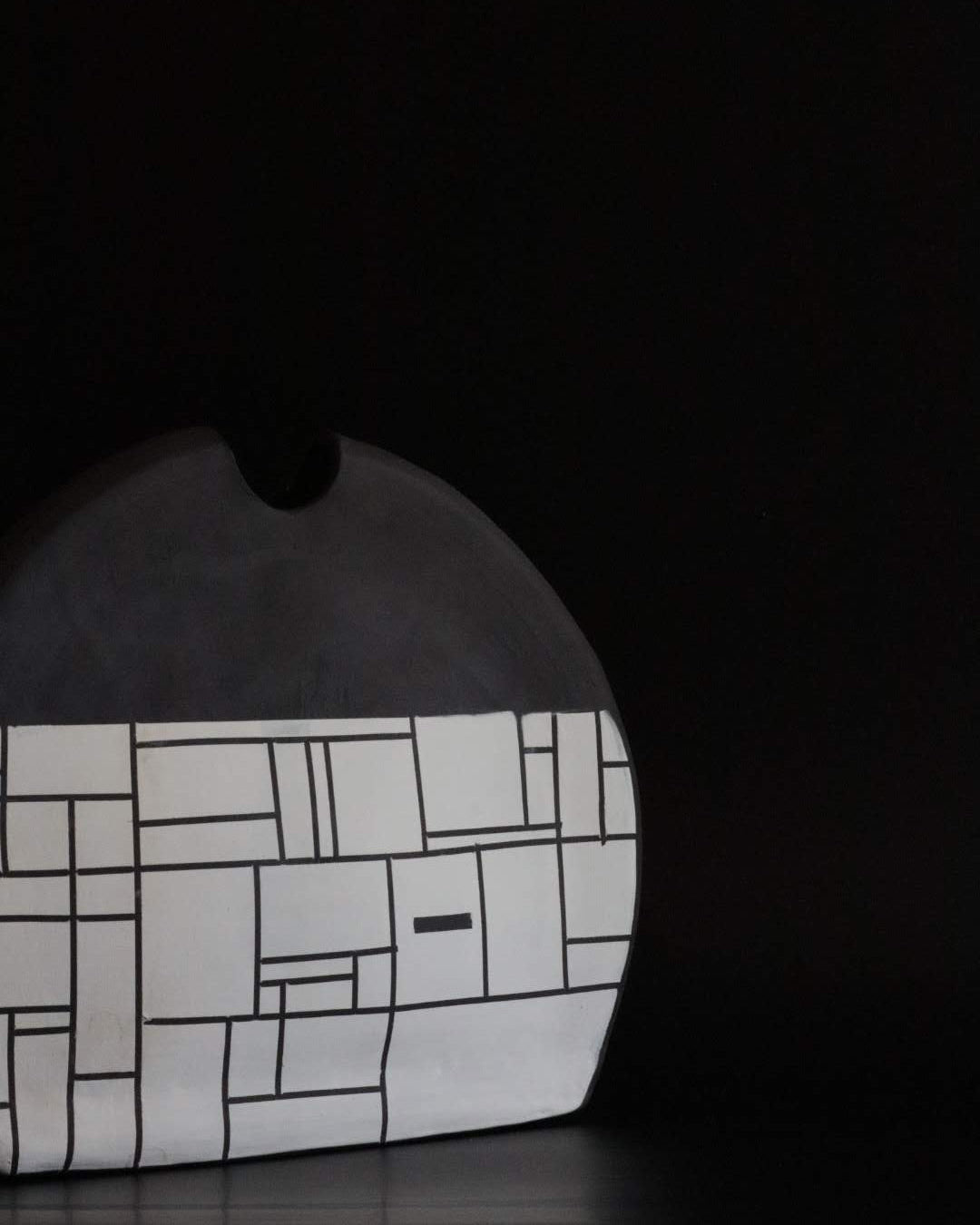 Black ceramic vessel with geometric block design