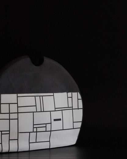 Black ceramic vessel with geometric block design