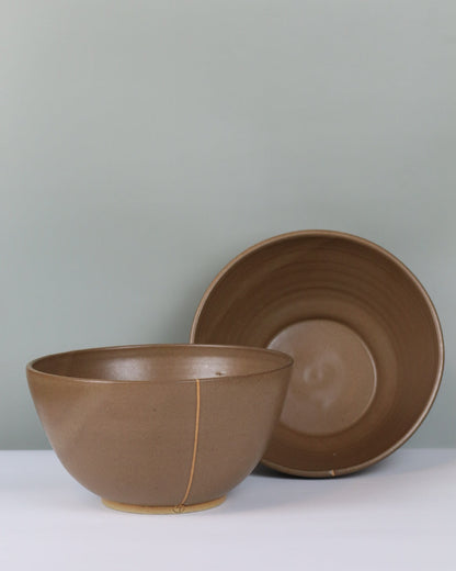 Brown ceramic bowls on a grey background