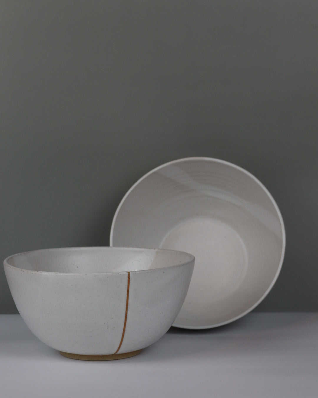 Large white ceramic bowls on a grey background