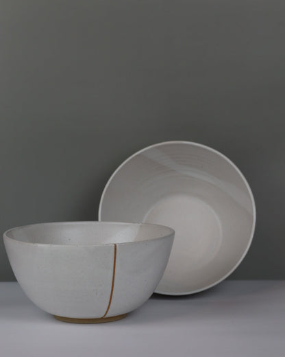 Large white ceramic bowls on a grey background
