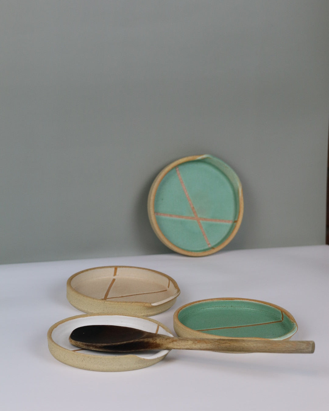 ceramic spoon rests with wooden spoon resting on them