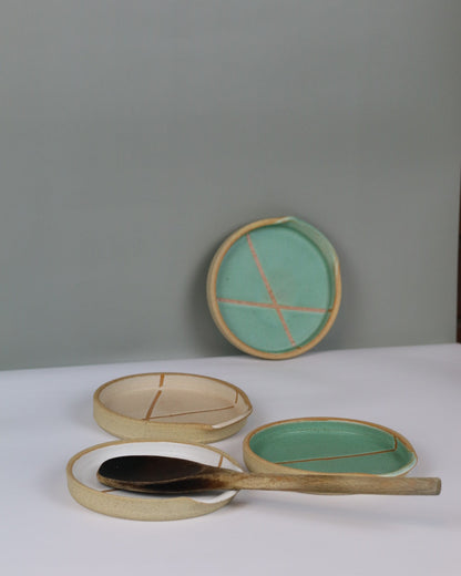 ceramic spoon rests with wooden spoon resting on them